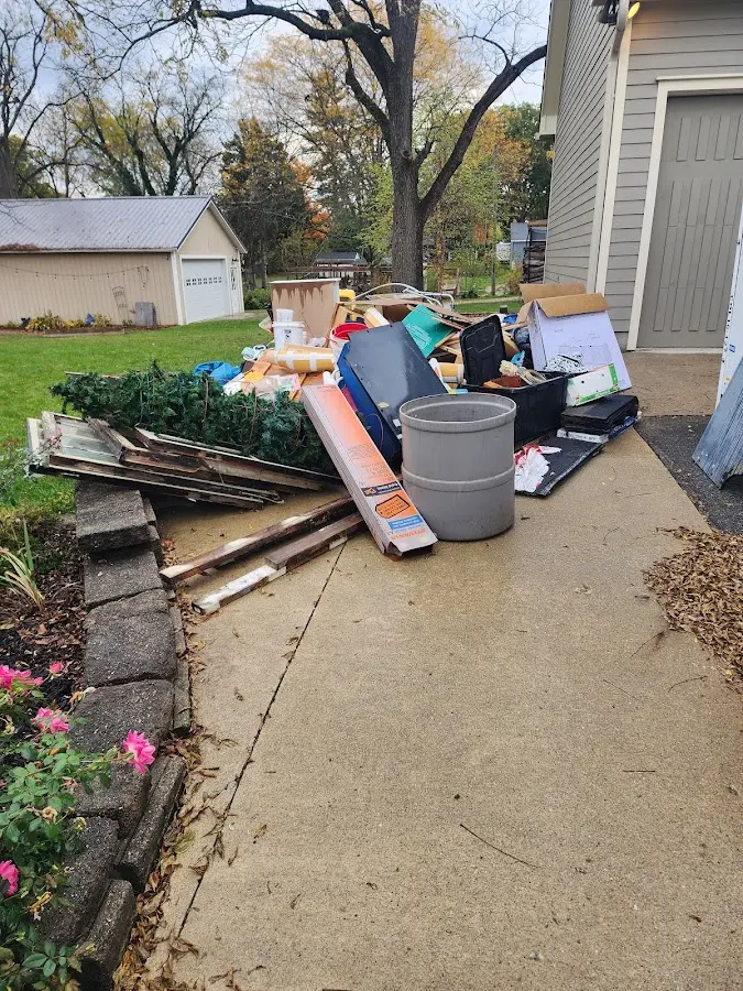 Dumpster being loaded with debris for 12 Yard Dumpster Rental in Richmond